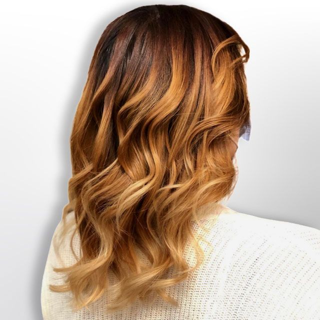 Wavy auburn hair with blonde highlights