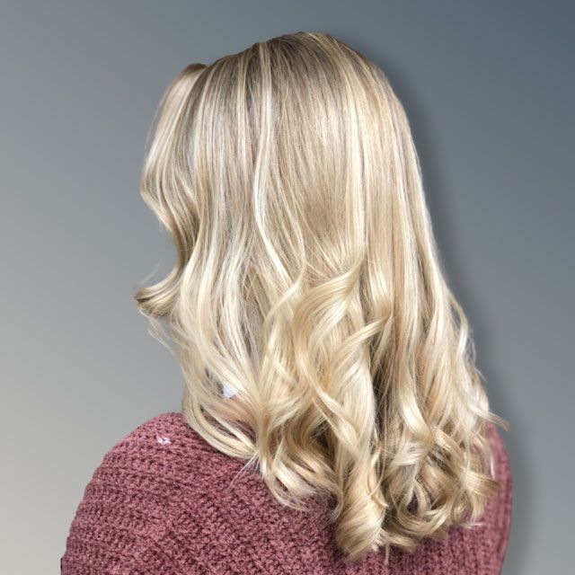 Blonde wavy hair styled in loose curls
