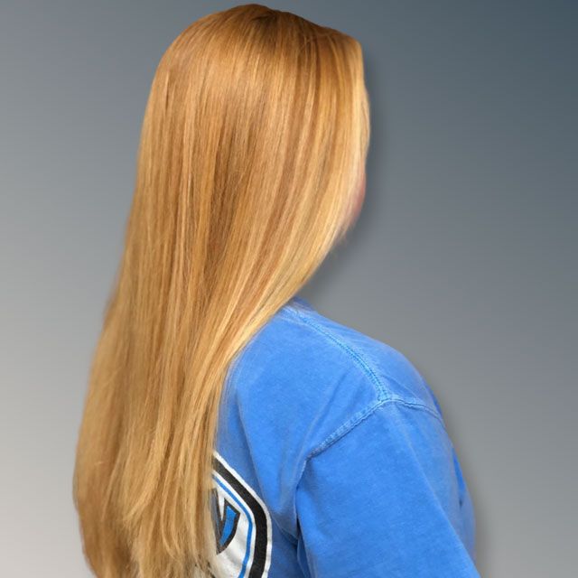 Back view of a person with long blonde hair