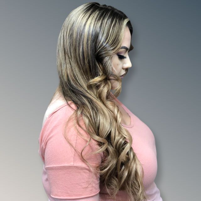 Profile view of a woman with long blonde curls