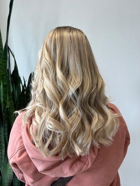 Blonde wavy hair styled in loose curls