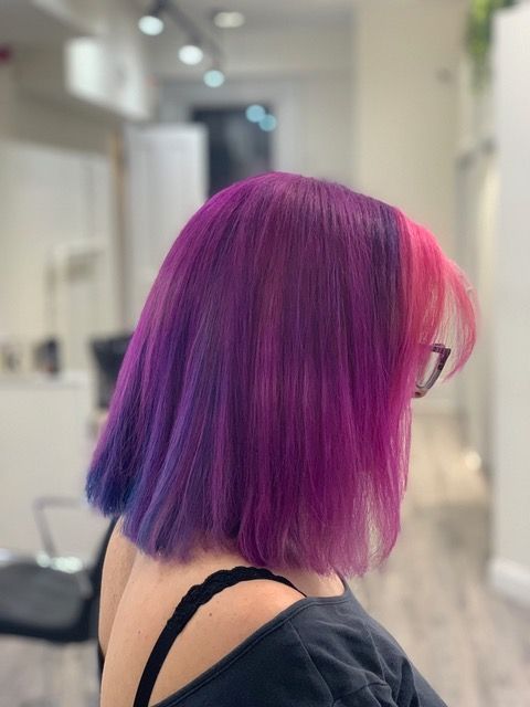 Side view of a person with purple and pink bob hair
