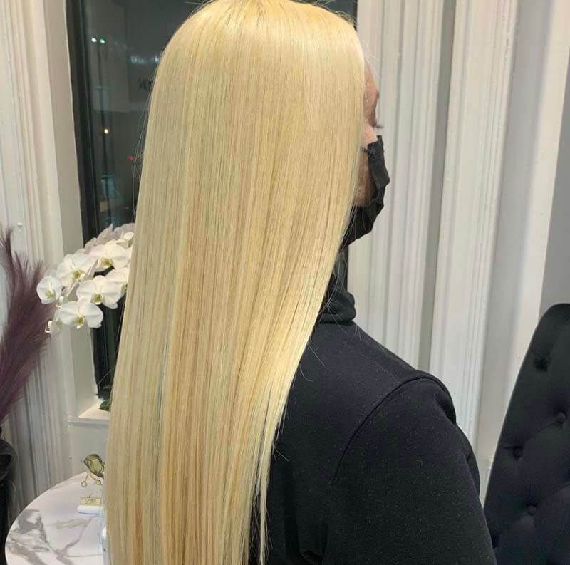 Long straight platinum-blonde hair shown from the back
