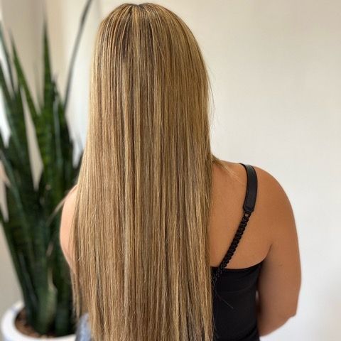 Back view of a person with long blonde hair