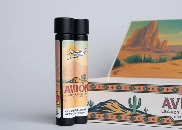 two preroll containers standing up, next to a box, grey background