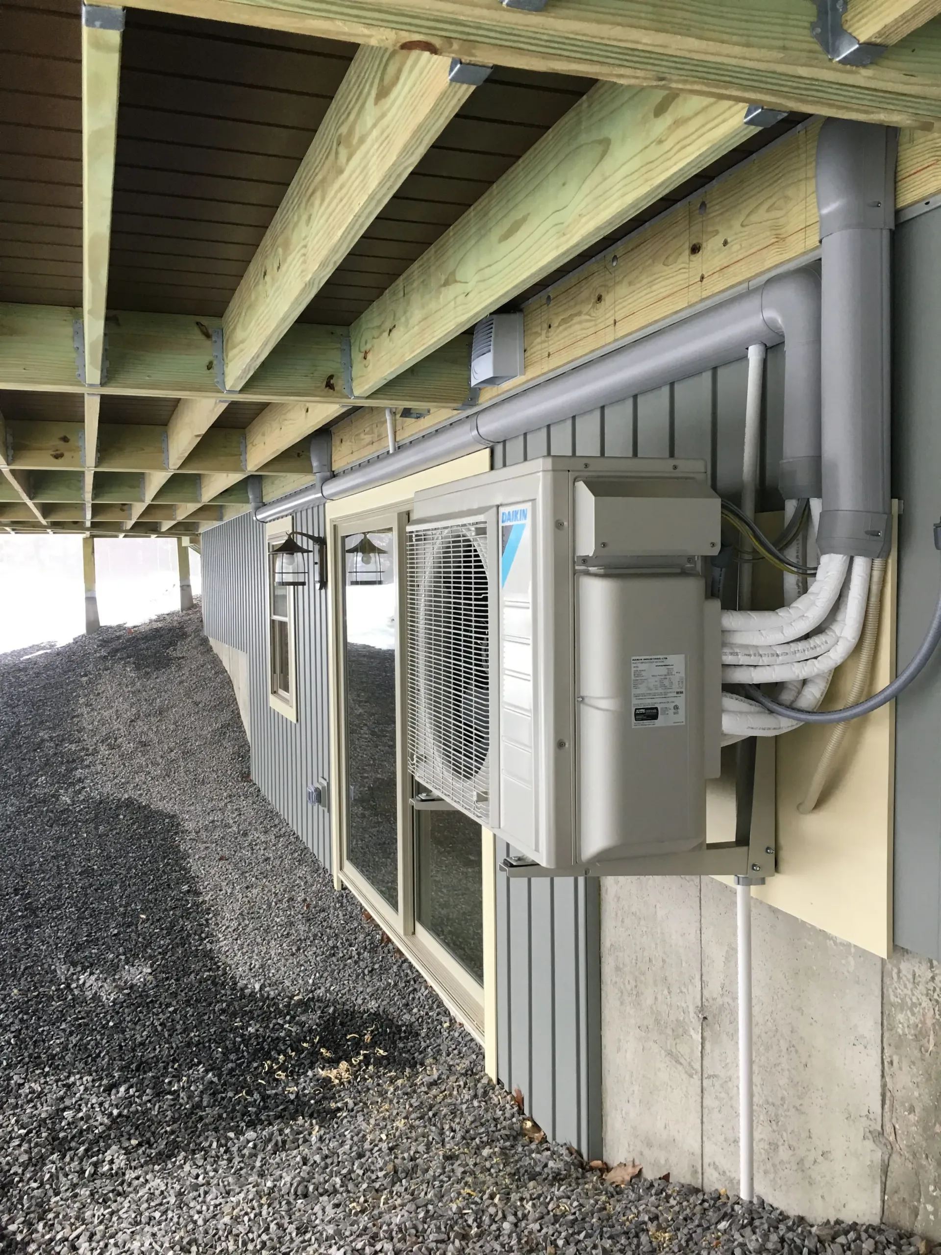 A large air conditioner is mounted on the side of a building.