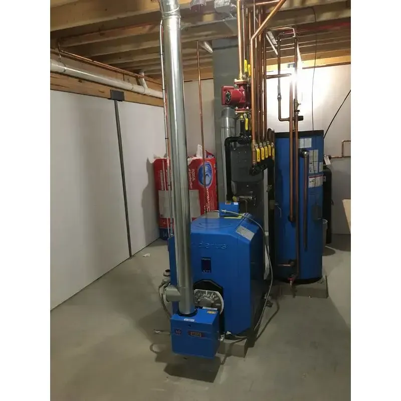 A blue boiler is sitting in a basement next to a fire extinguisher.
