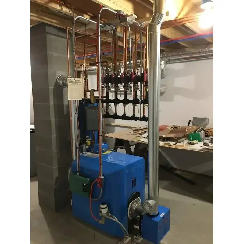 A blue boiler is sitting in a basement next to a pipe.