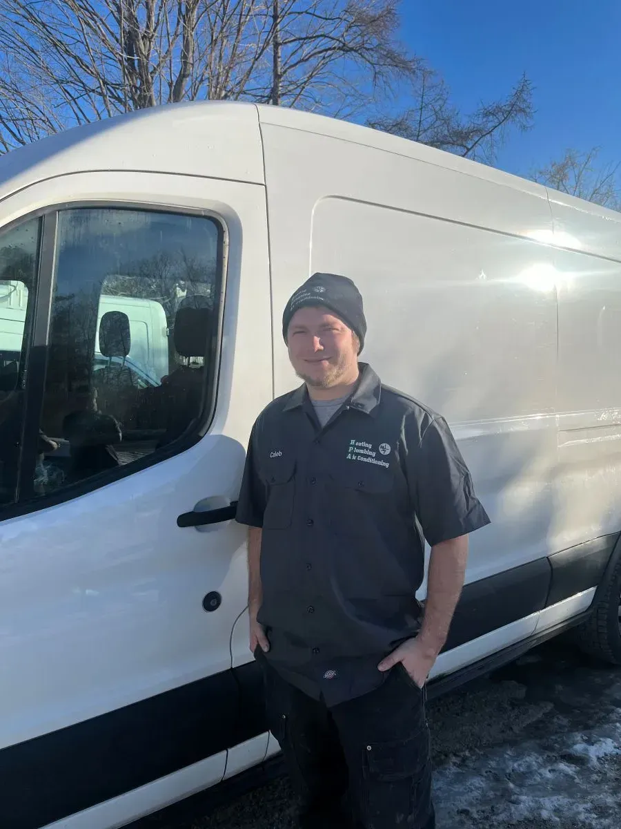 A man is standing in front of a white van.