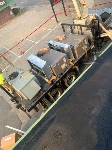 A truck with boxes on the back of it is parked in a parking lot.