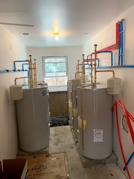 A room filled with water heaters and pipes.