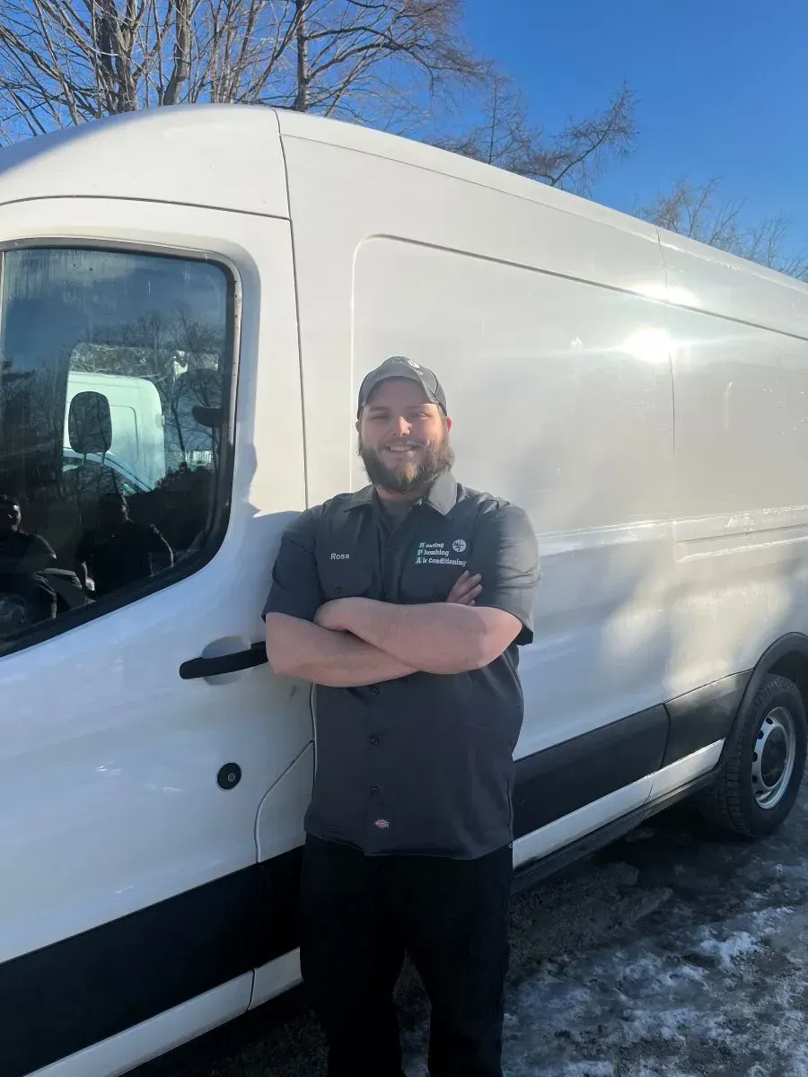 A man is standing in front of a white van.