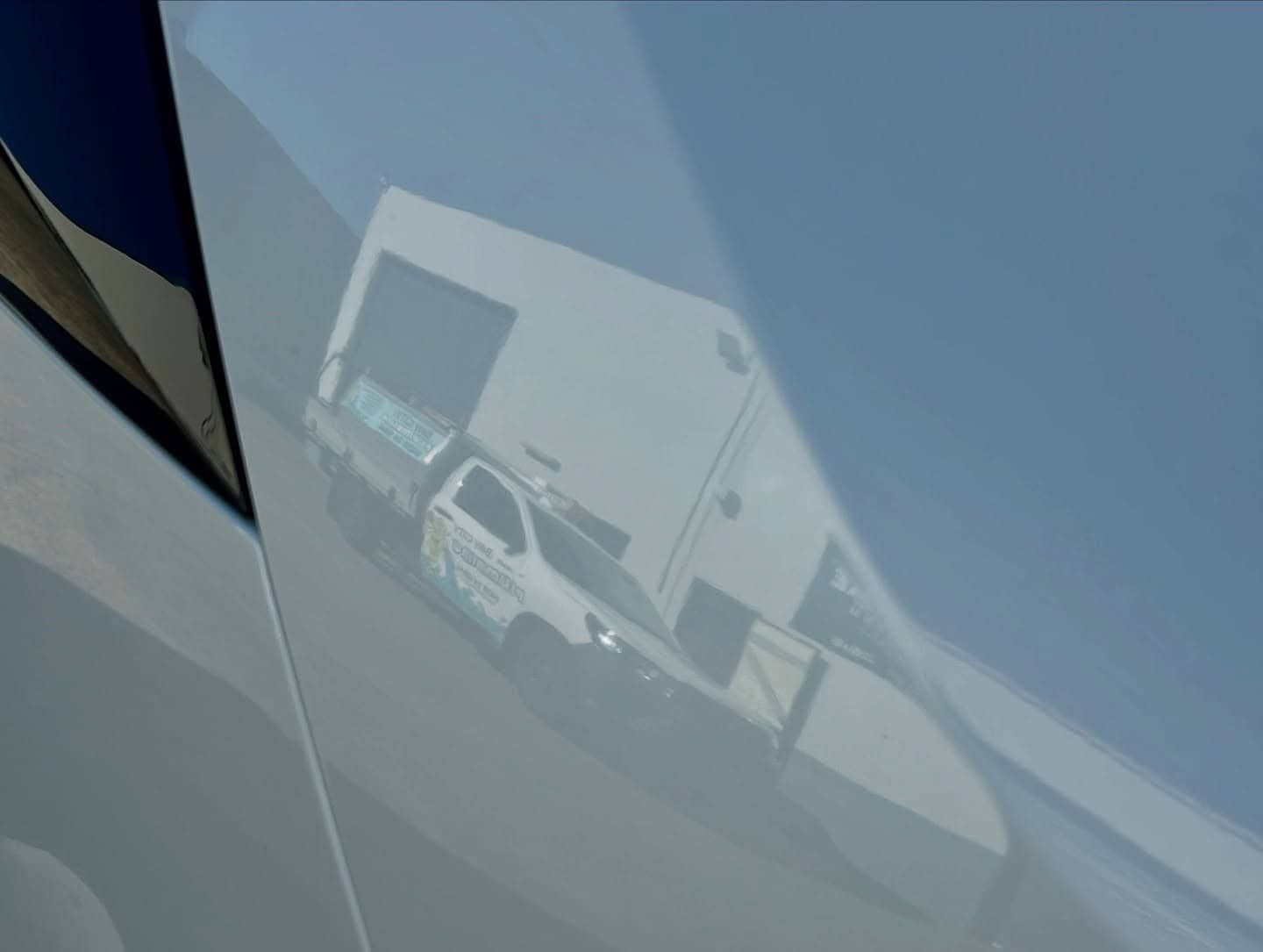 A Close Up Of A Car Door With A Reflection Of A Building In It — Tim Kratzke Detailing in Pialba, QLD
