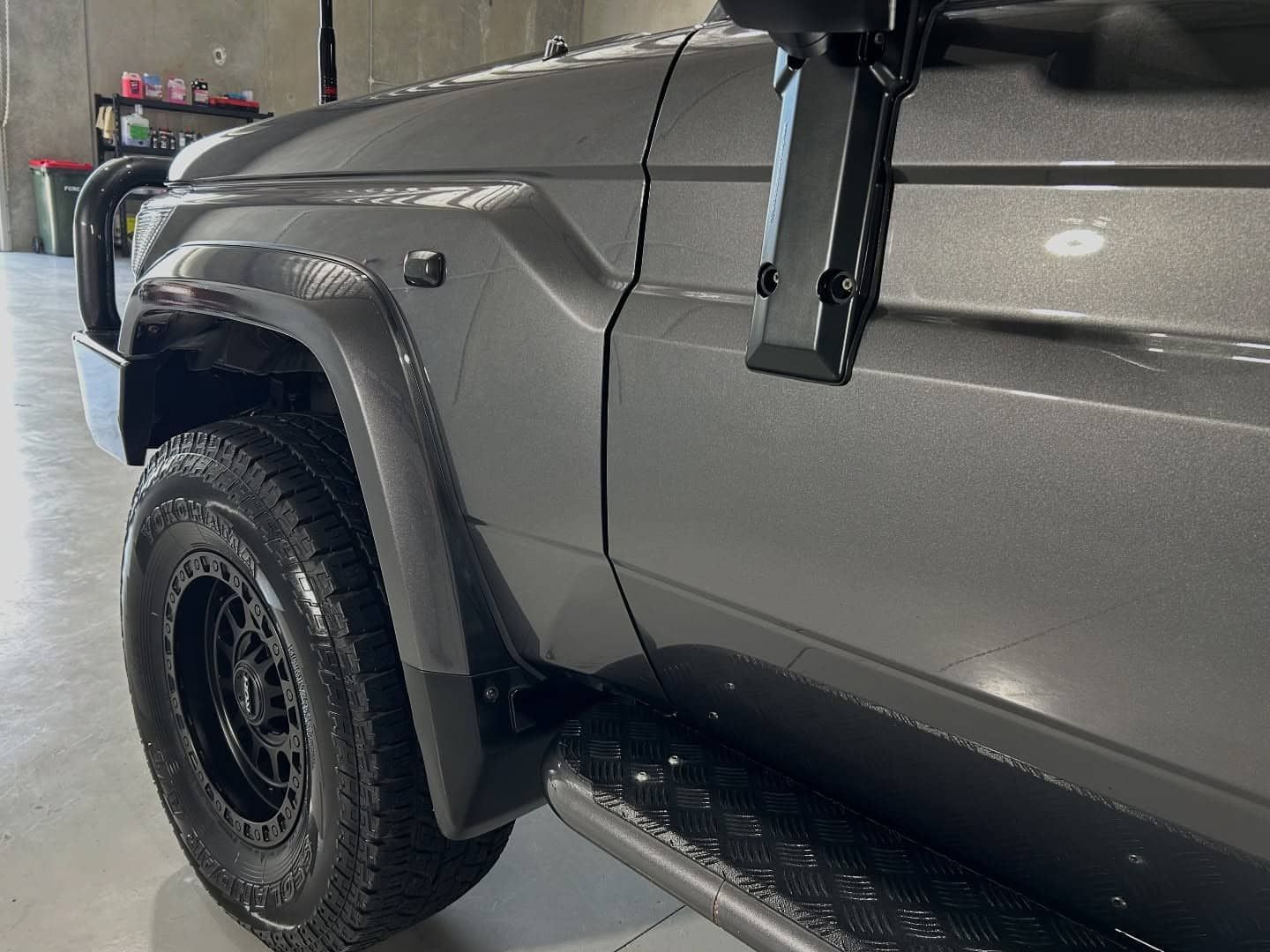 A Gray Truck With Black Tires Is Parked In A Garage — Tim Kratzke Detailing in Pialba, QLD
