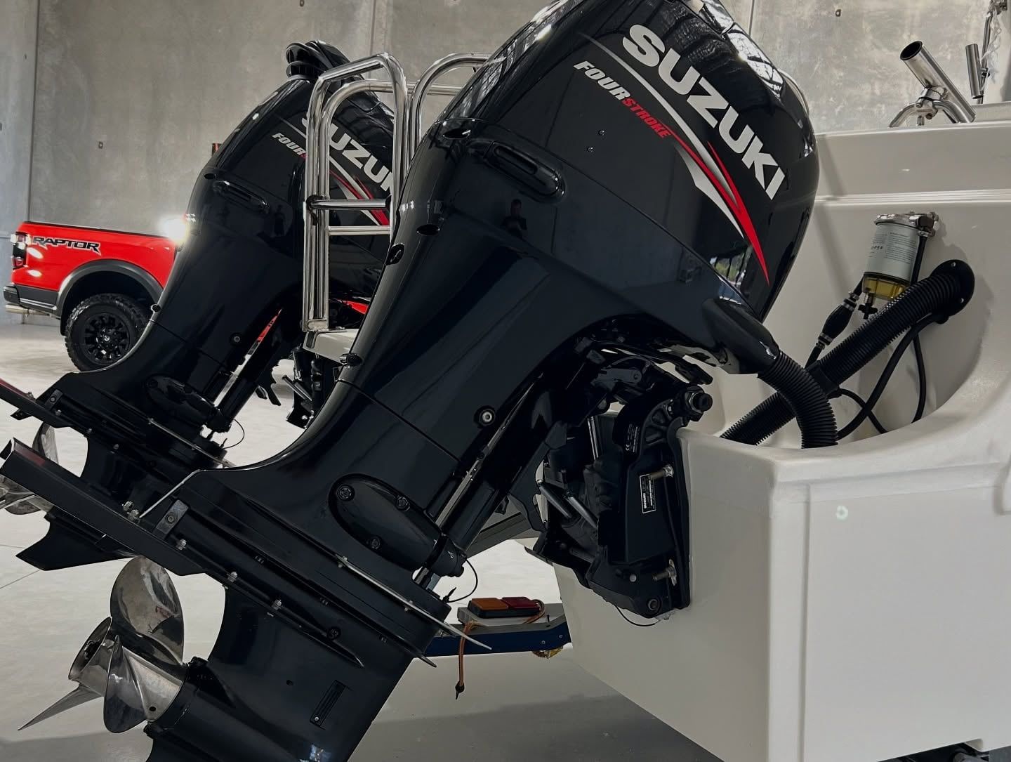 Two Suzuki Outboards Are Sitting On Top Of A Boat — Tim Kratzke Detailing in Pialba, QLD