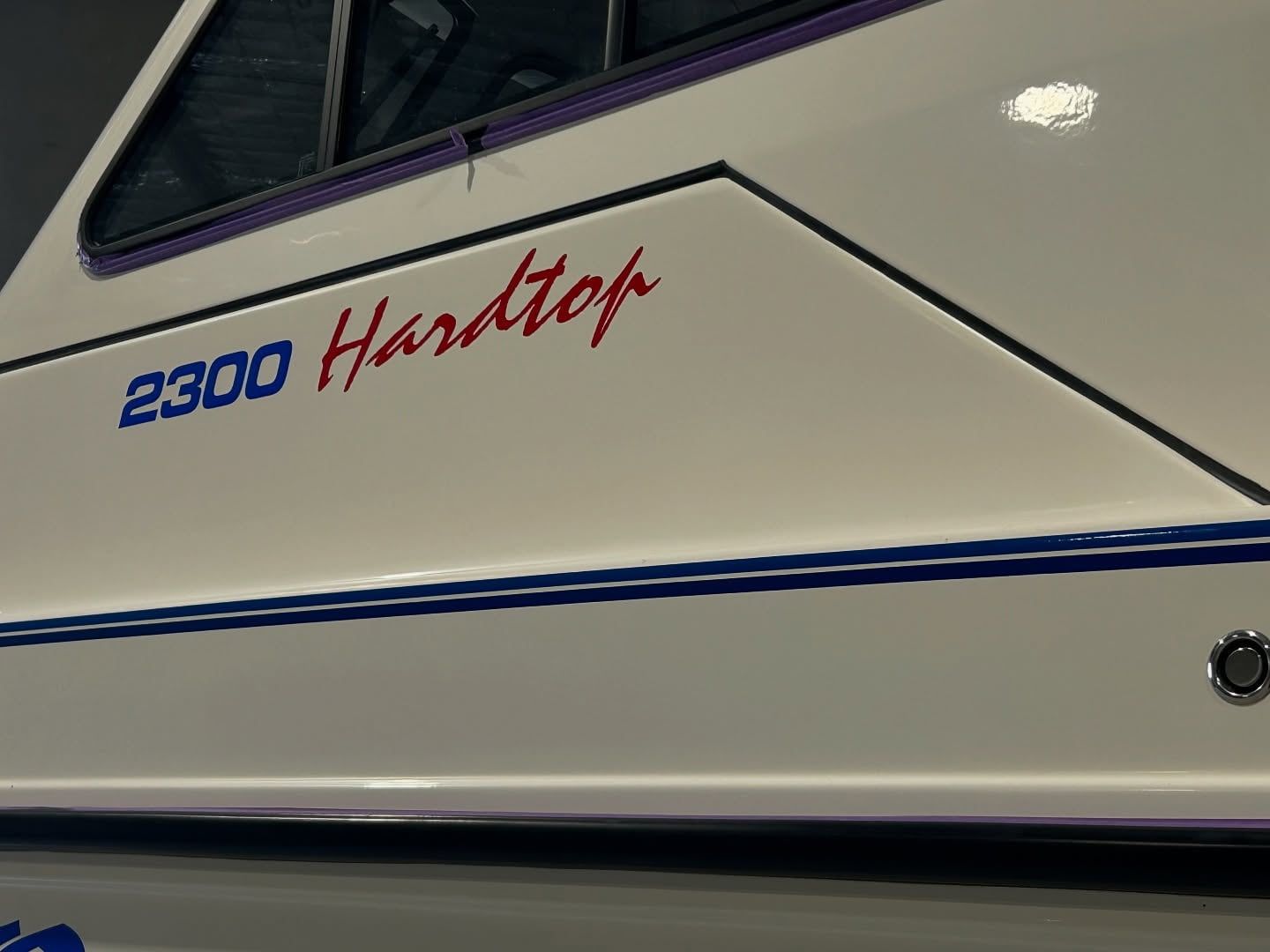 A White Boat With The Name 2300 Hardtop On The Side — Tim Kratzke Detailing in Pialba, QLD