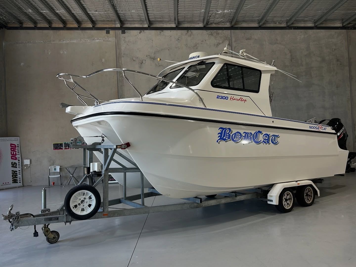 A White Boat Is On A Trailer In A Warehouse — Tim Kratzke Detailing in Pialba, QLD