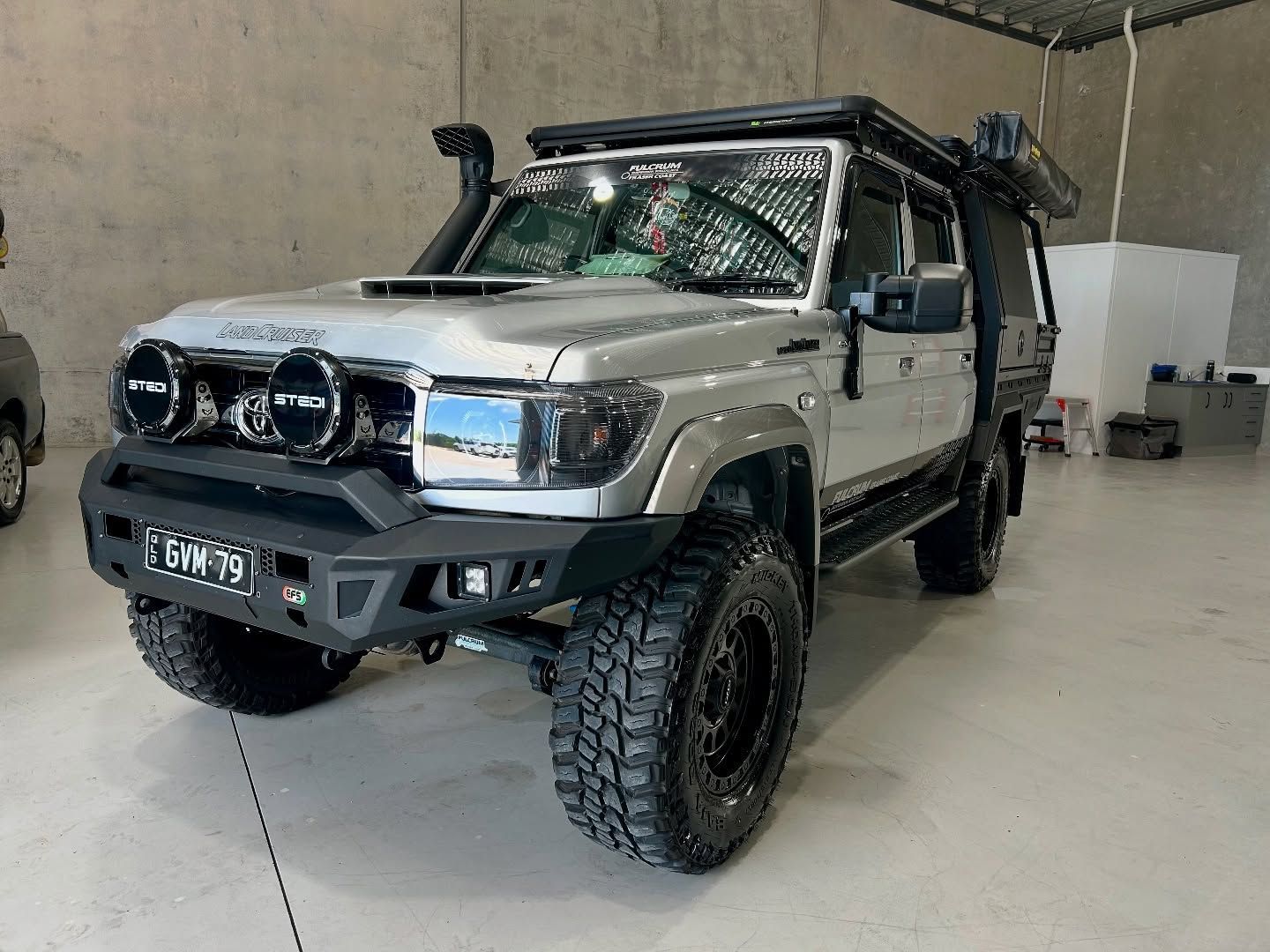 Silver Toyota Land Cruiser truck modified with off-road accessories parked inside a garage — Tim Kratzke Detailing in Pialba, QLD