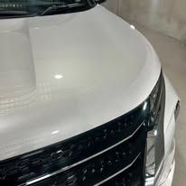 Close-up of a white car hood and grill — Tim Kratzke Detailing in Pialba, QLD