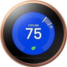 White digital thermostat displaying 75°F on a wall.