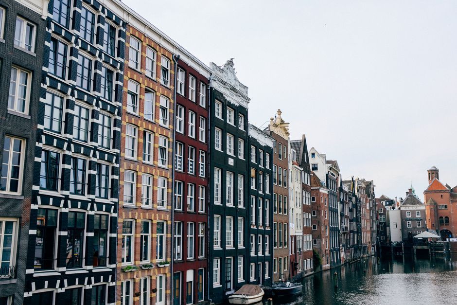 Row of old brick canal houses along an Amsterdam canal