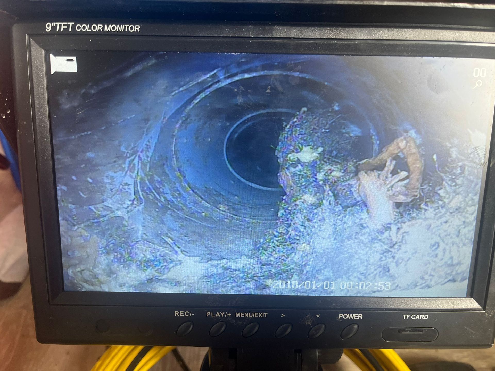 A CRT TV displays a dark blue swirling scene with a person on the right side.
