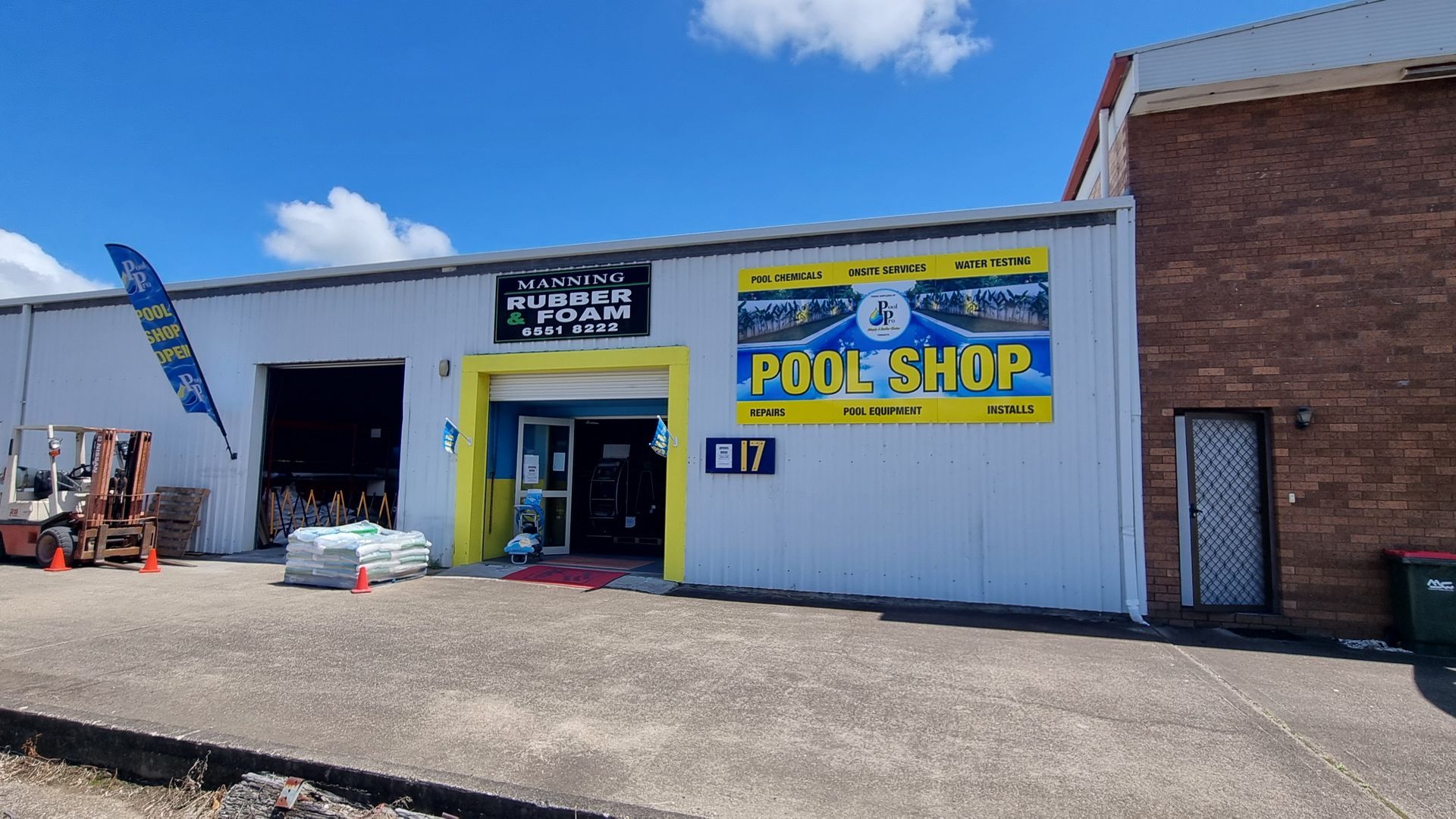 A White Building With A Sign That Says Pool Shop On It — Manning Pools, Rubber & Foam In Taree, NSW