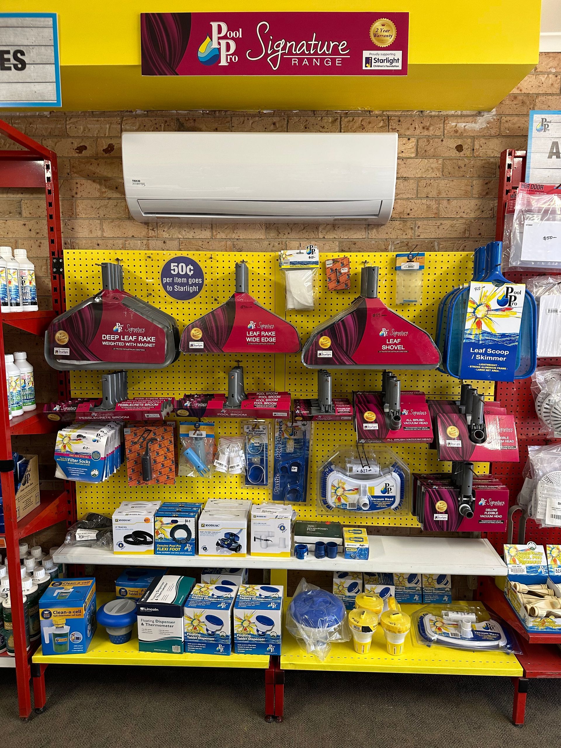 Display of pool cleaning supplies, including brushes, filters, and accessories, on shelves in a store. — Manning Pools, Rubber & Foam In Taree, NSW
