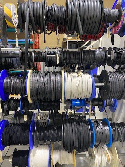 A Bunch Of Spools Of Wires Hanging On A Rack — Manning Pools, Rubber & Foam In Taree, NSW