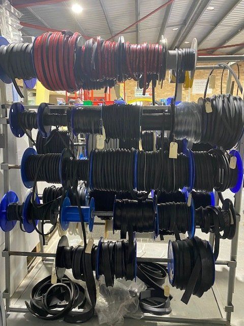 A Bunch Of Spools Of Wires Hanging On A Rack — Manning Pools, Rubber & Foam In Taree, NSW