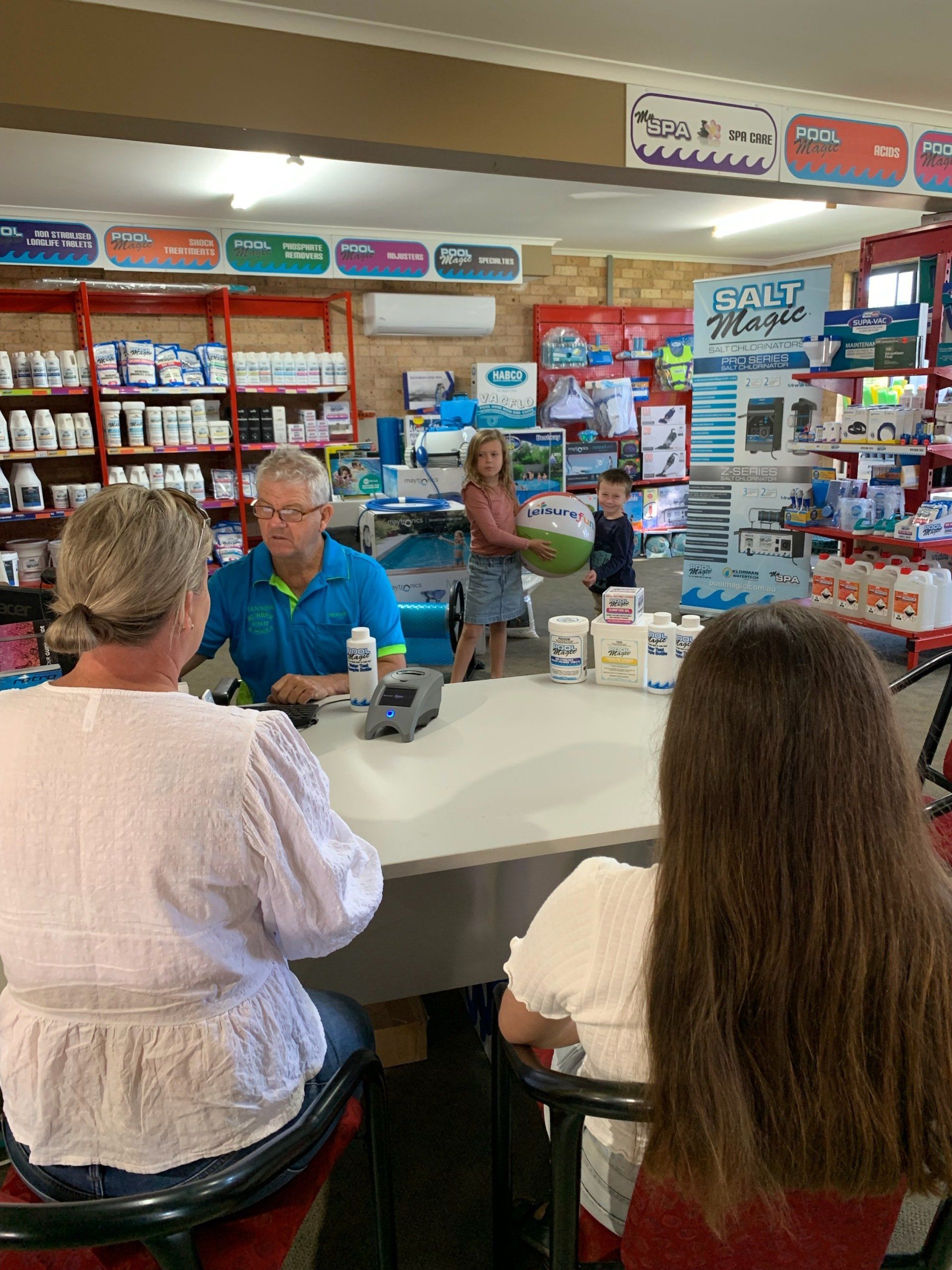 A Group Of People Are Sitting At A Table In A Store — Manning Pools, Rubber & Foam In Forster, NSW