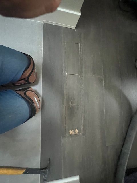 Professional repair of damaged hardwood floorboards