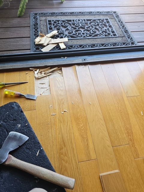 damaged hardwood flooring undergoing detailed repair work