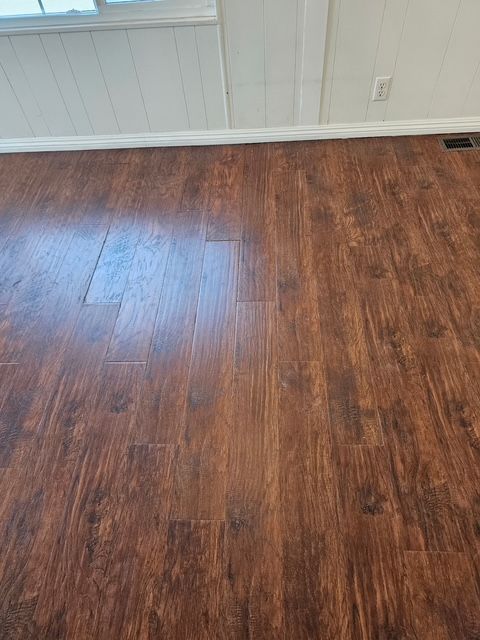 Professional repair of worn laminate flooring surfaces