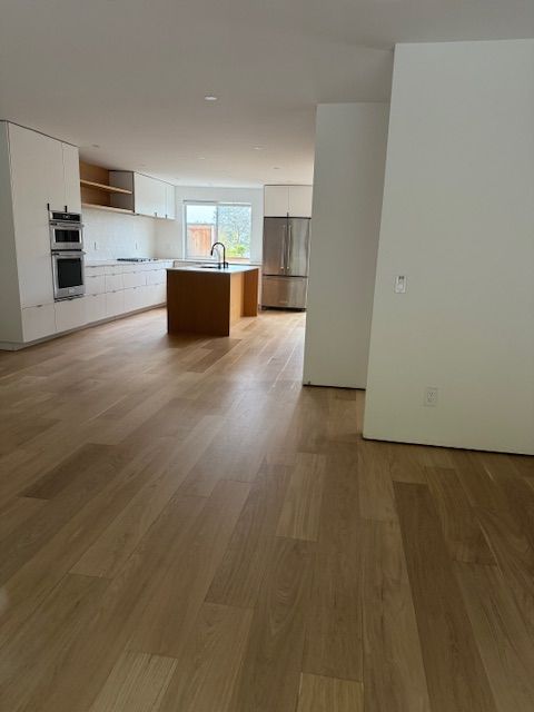 Removing worn flooring finish during hardwood restoration