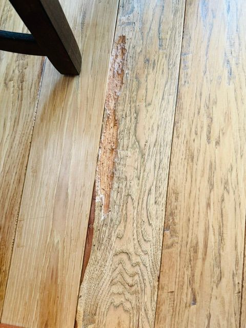 Flooring contractor restoring worn and damaged residential floors