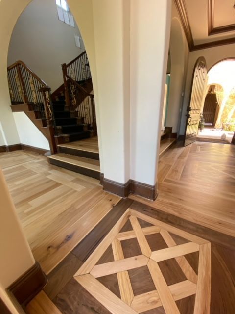 Applying stain to professionally sanded hardwood flooring