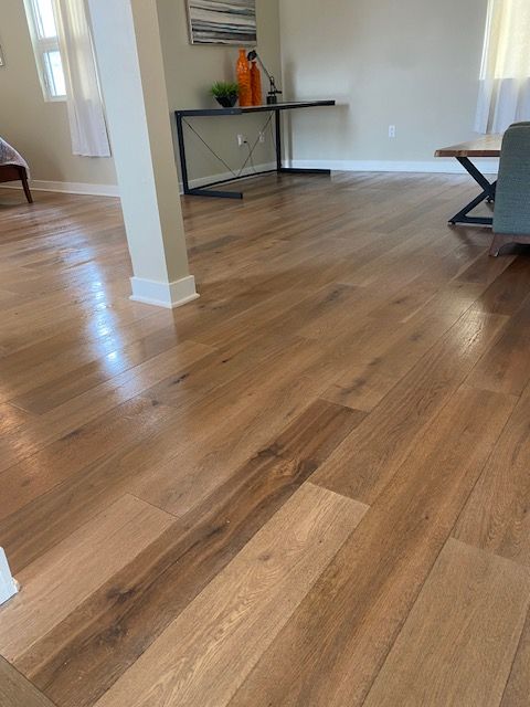 Hardwood floor stain application by flooring professionals