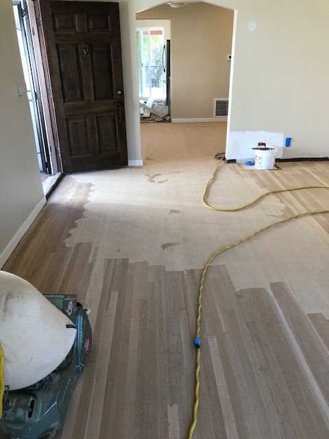 Hardwood floor refinishing with a smooth protective surface