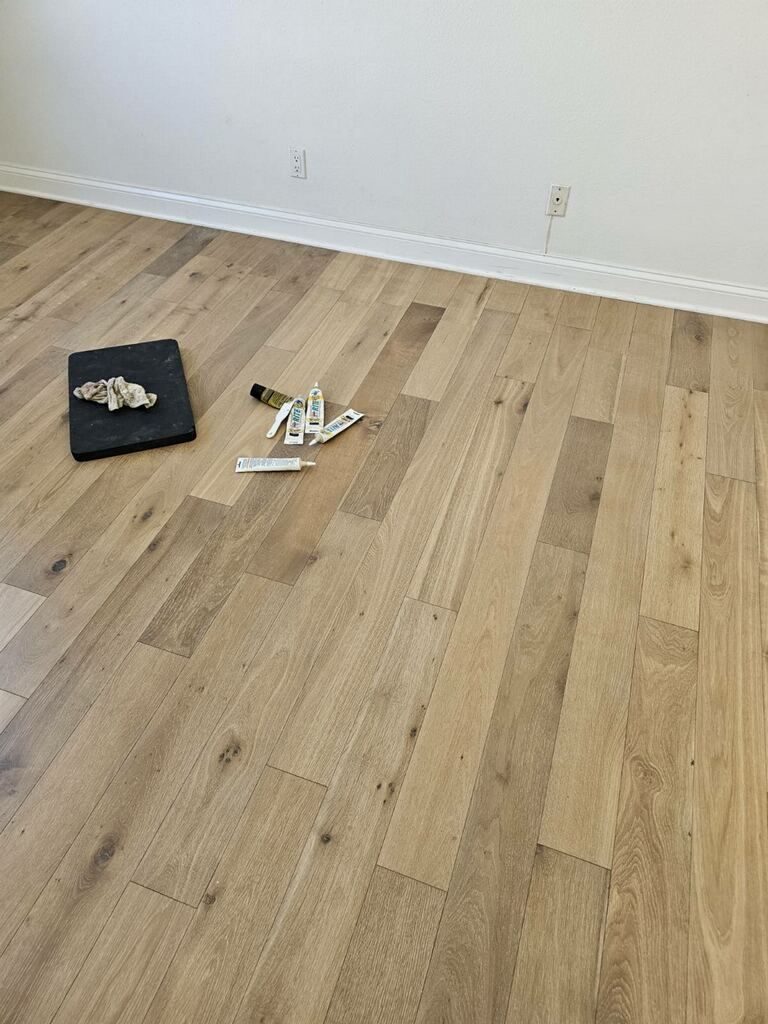 Damaged wood flooring plank repair in San Diego