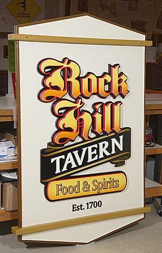 A large sign for rock hill tavern food and spirits