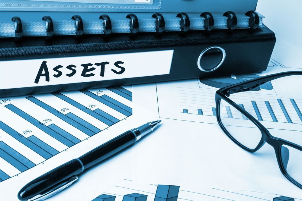 A Pen, Glasses and a Binder With the Word Assets on It — Repo Busters Wyong In Wyong, NSW