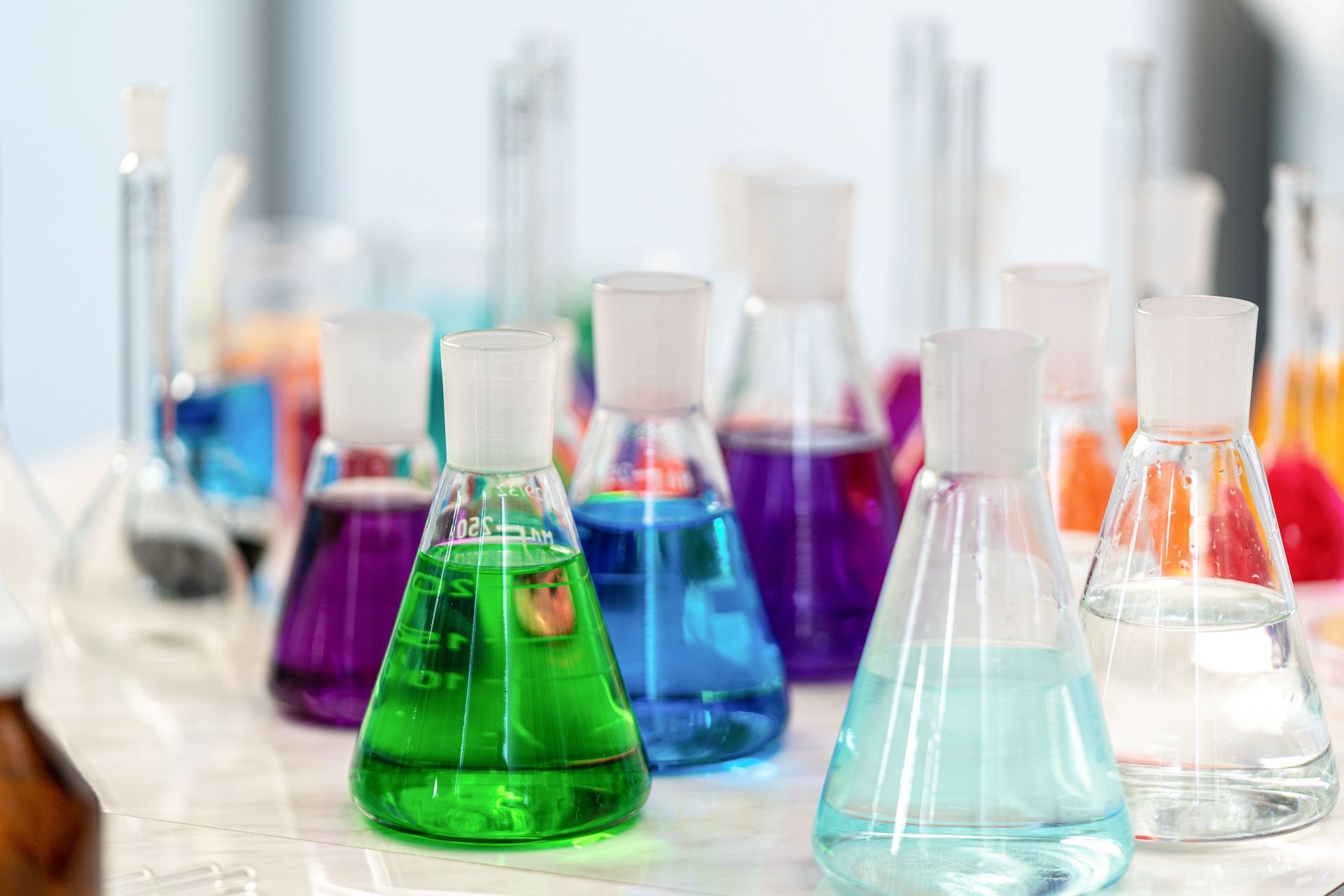 Conical flasks with various coloured liquids