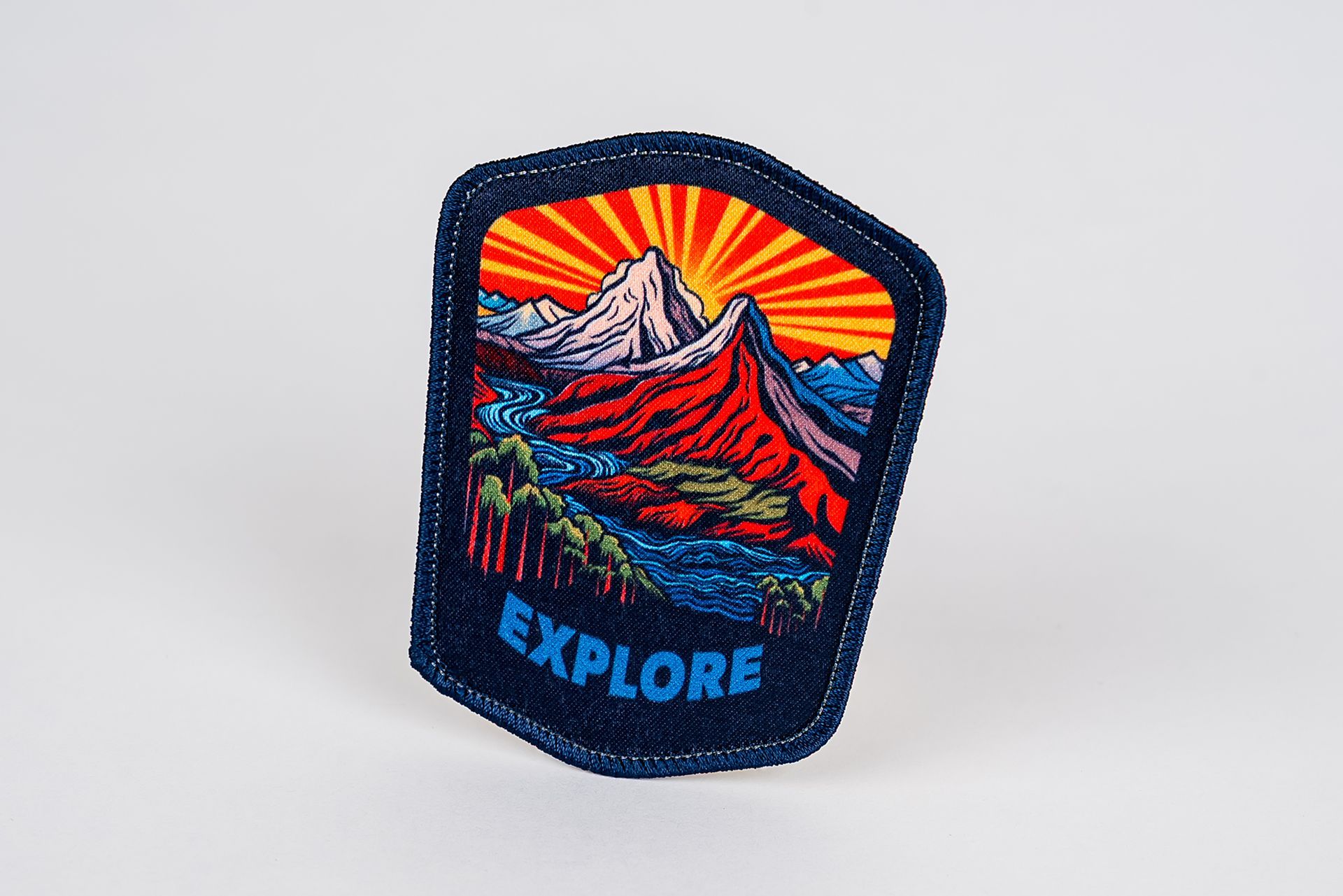Patch with mountain scene, sunburst, and the word