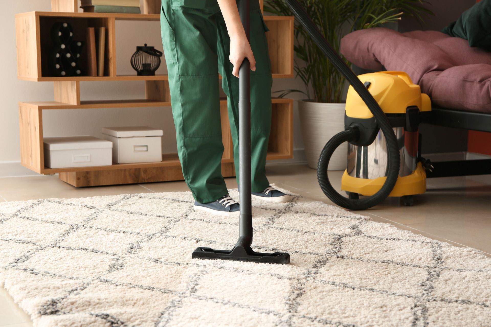 A man is cleaning a carpet. A person is cleaning a carpet.