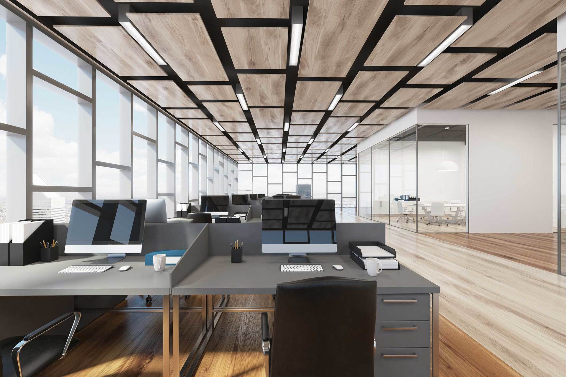 A large office with a lot of windows and cubicles