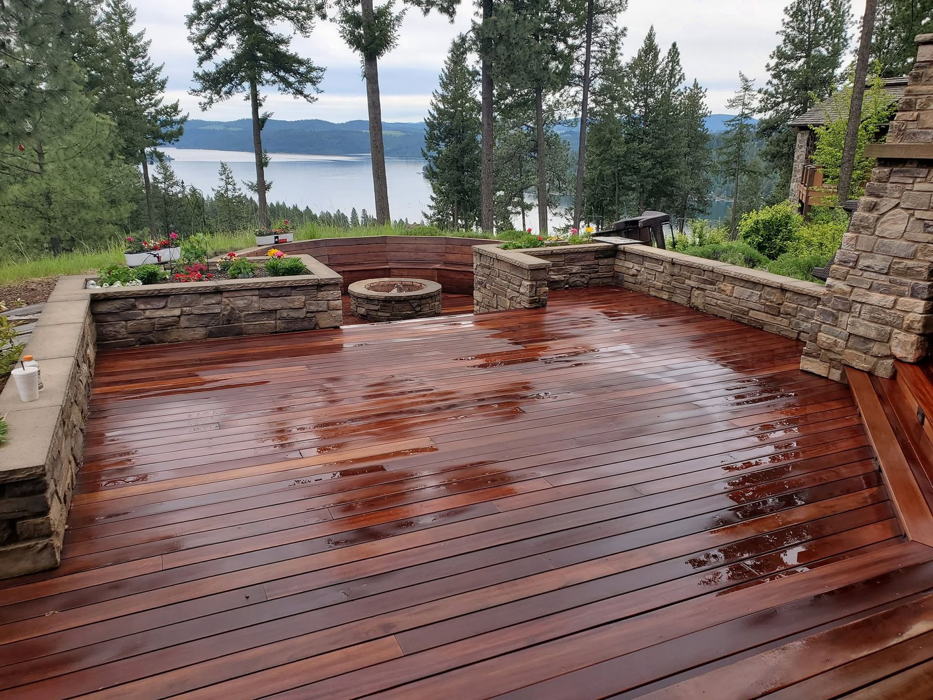 Wooden corner deck bench with built-in seating and dark tiled floor below