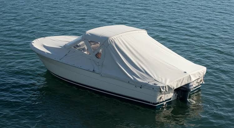 White covered motorboat floating on calm blue water