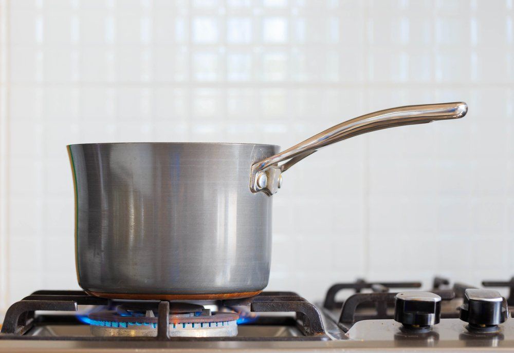 A Pot on a Gas Cooker — Plumbers in Harlaxton, QLD