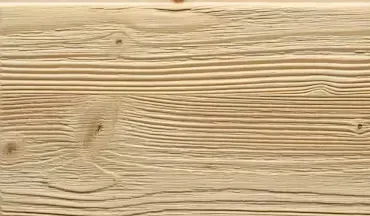 Primo piano di una tavola di legno marrone chiaro con venature e nodi visibili.